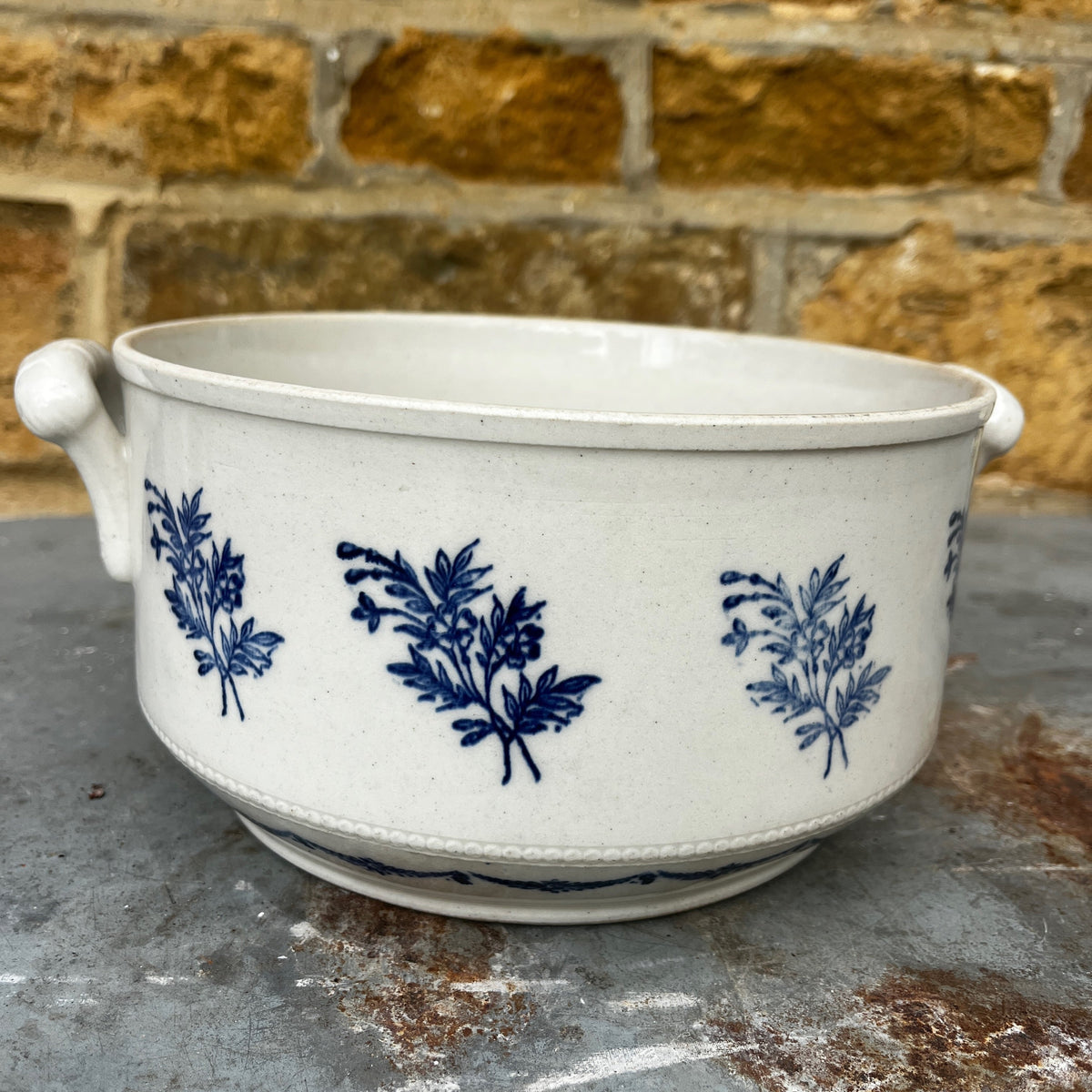 A vintage French provincial White Eartenware Bowl with Cobalt Blue Floral Decorations