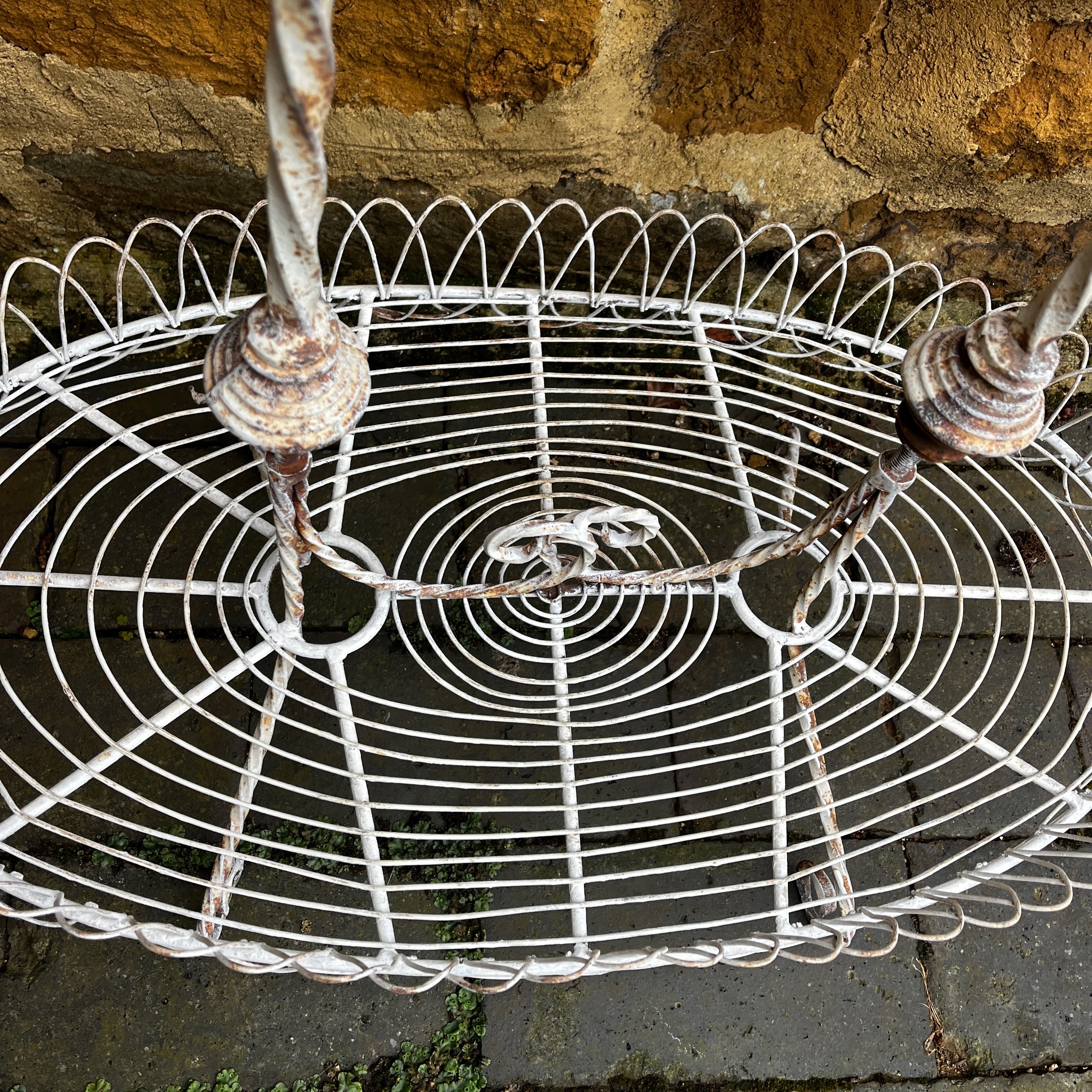 A Vintage Two-Tiered French Wirework Plant Stand with Ornate Detailing