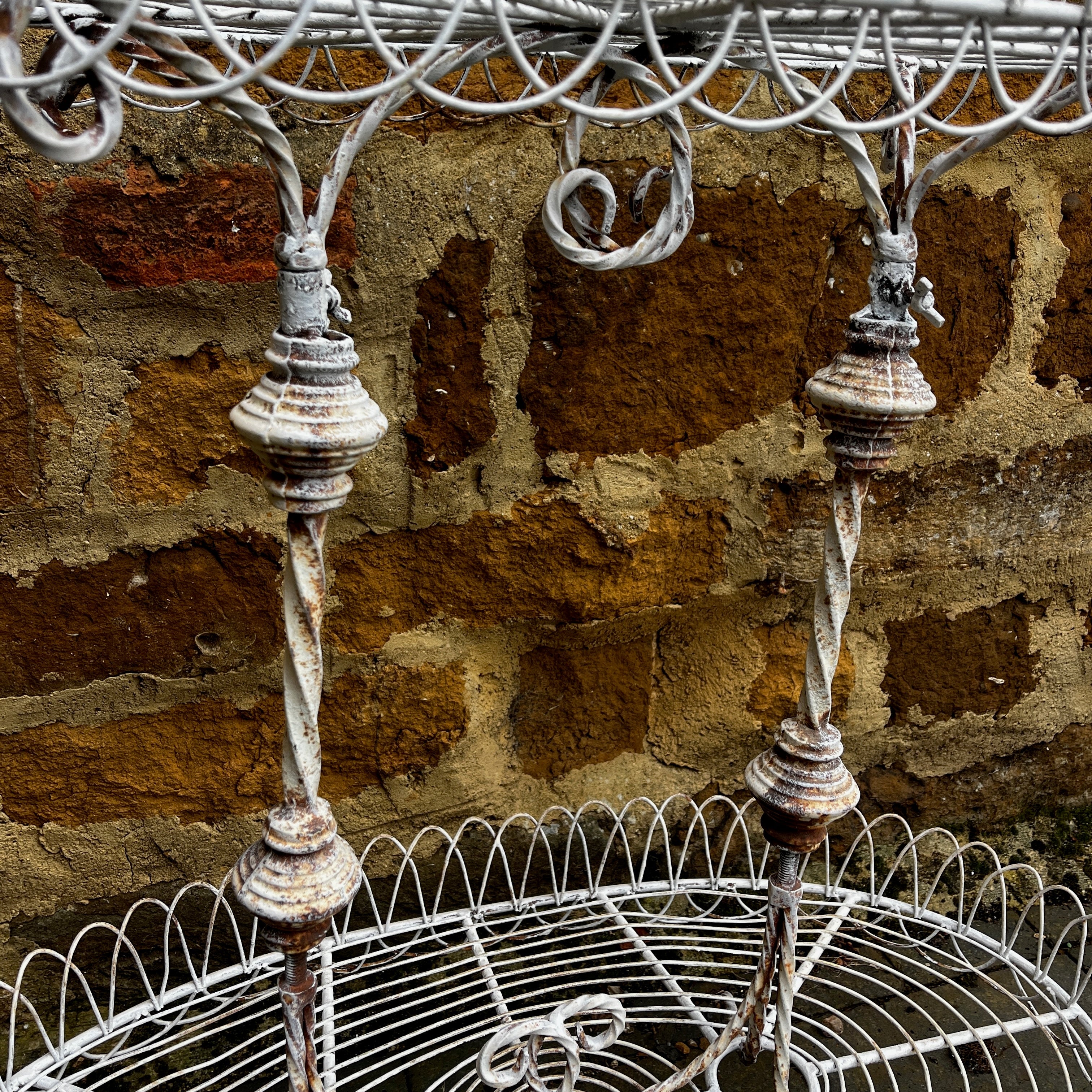 A Vintage Two-Tiered French Wirework Plant Stand with Ornate Detailing