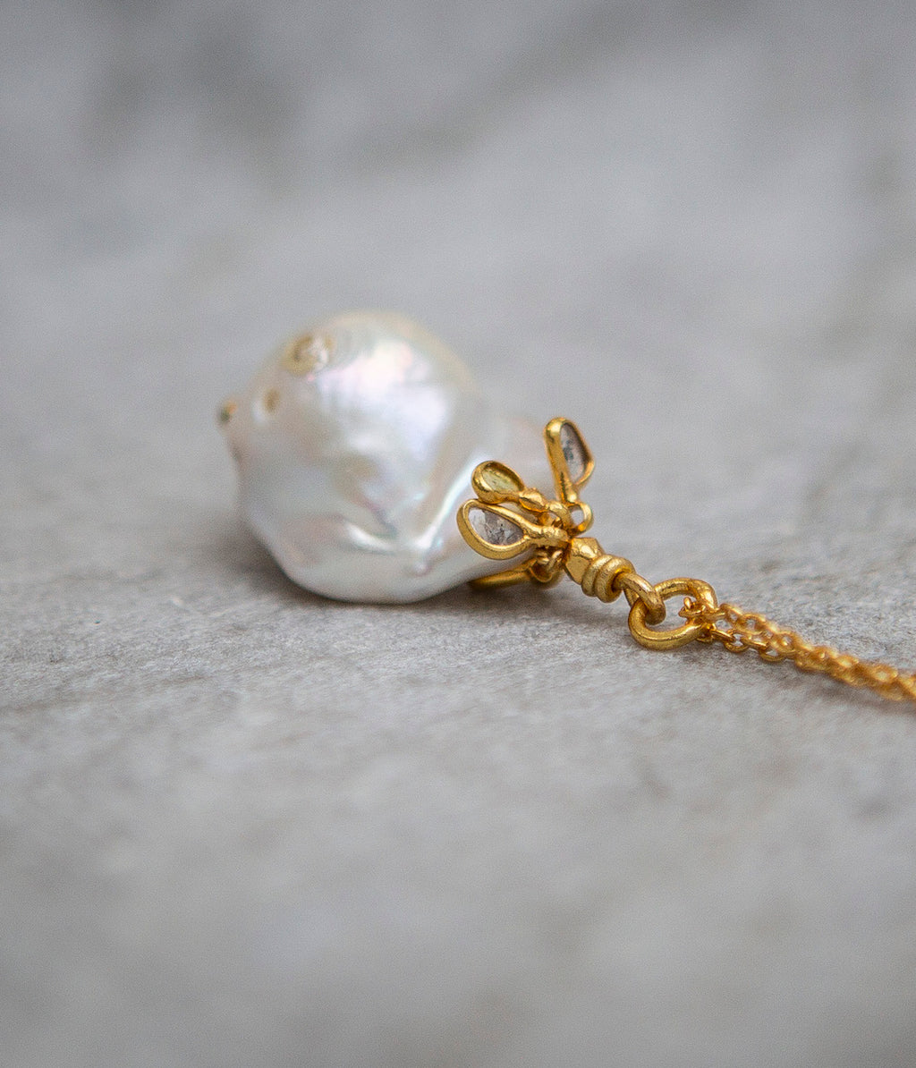 Baroque pearl and uncut diamond pendant